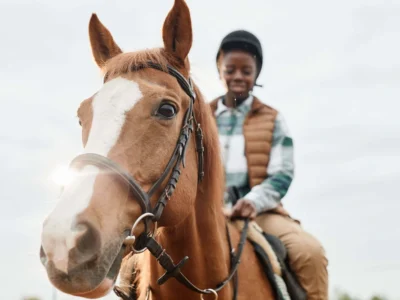 Hippotherapy. Girl riding a horse.