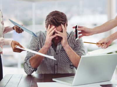 Work stress: definition, types, causes and consequences for health. Man under stress at work.