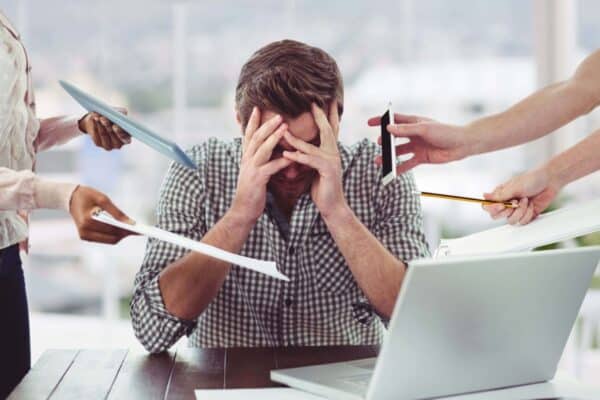 Work stress: definition, types, causes and consequences for health. Man under stress at work.