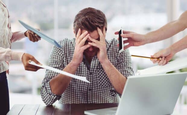 Work stress: definition, types, causes and consequences for health. Man under stress at work.