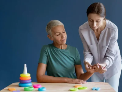 Occupational therapist, performing a daily living activity for a patient