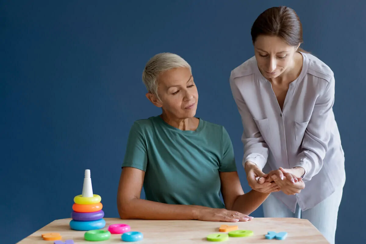Occupational therapist, performing a daily living activity for a patient