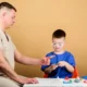 Neurodevelopmental disorders. Child with autism playing with a professional.