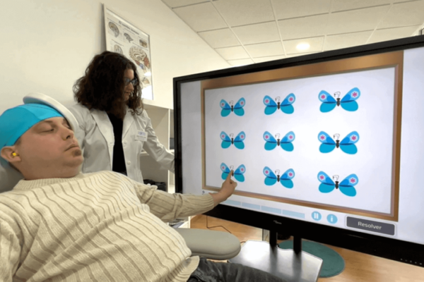 Transcranial magnetic stimulation and cognitive rehabilitation with NeuronUP in a patient in the presence of his therapist.