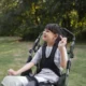 Cerebral palsy: understanding and managing a complex neurodevelopmental condition. Girl with cerebral palsy in a chair outdoors.