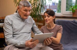Caring for People with Aphasia: Crucial Guidelines for Caregivers. A caregiver helping her patient.