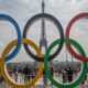 2024 Paralympic Games events and the importance of mental health. Symbolic rings of the Olympic Games and behind the Eiffel Tower.