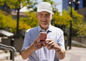 Reliability and validity of smartphone cognitive testing for frontotemporal lobar degeneration. Happy grandfather with a mobile phone in his hand