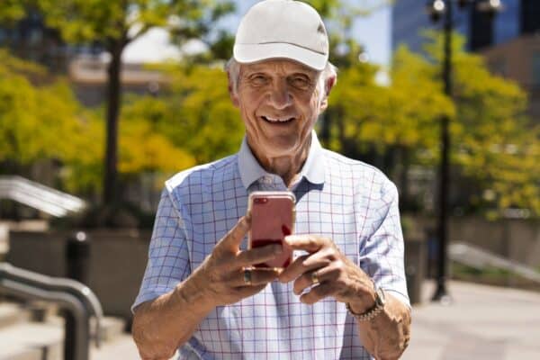 Reliability and validity of smartphone cognitive testing for frontotemporal lobar degeneration. Happy grandfather with a mobile phone in his hand