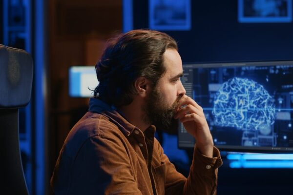 Deep learning model for the early detection of cognitive impairment from clinical notes in electronic medical records. A man looking at a digital computer screen