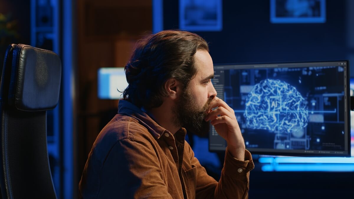 Deep learning model for the early detection of cognitive impairment from clinical notes in electronic medical records. A man looking at a digital computer screen